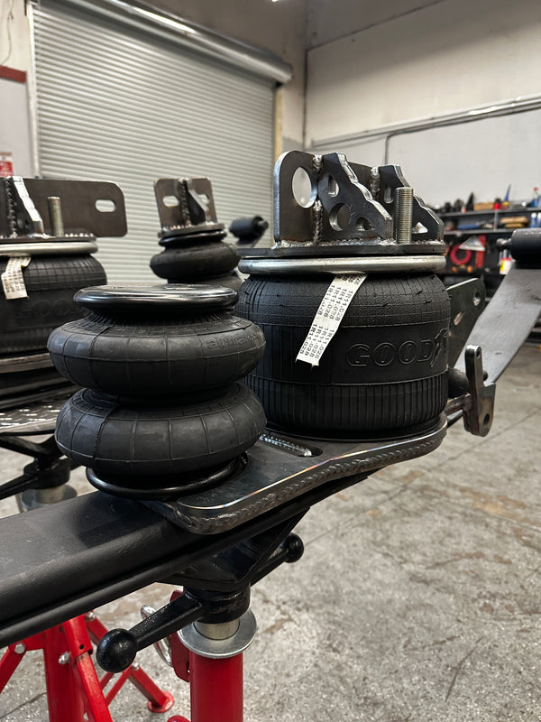 Heavy duty truck air suspension parts with mounting brackets in repair shop setting