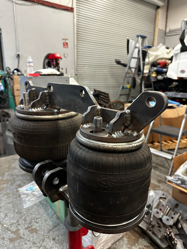 Close-up of a truck suspension system in a workshop setting