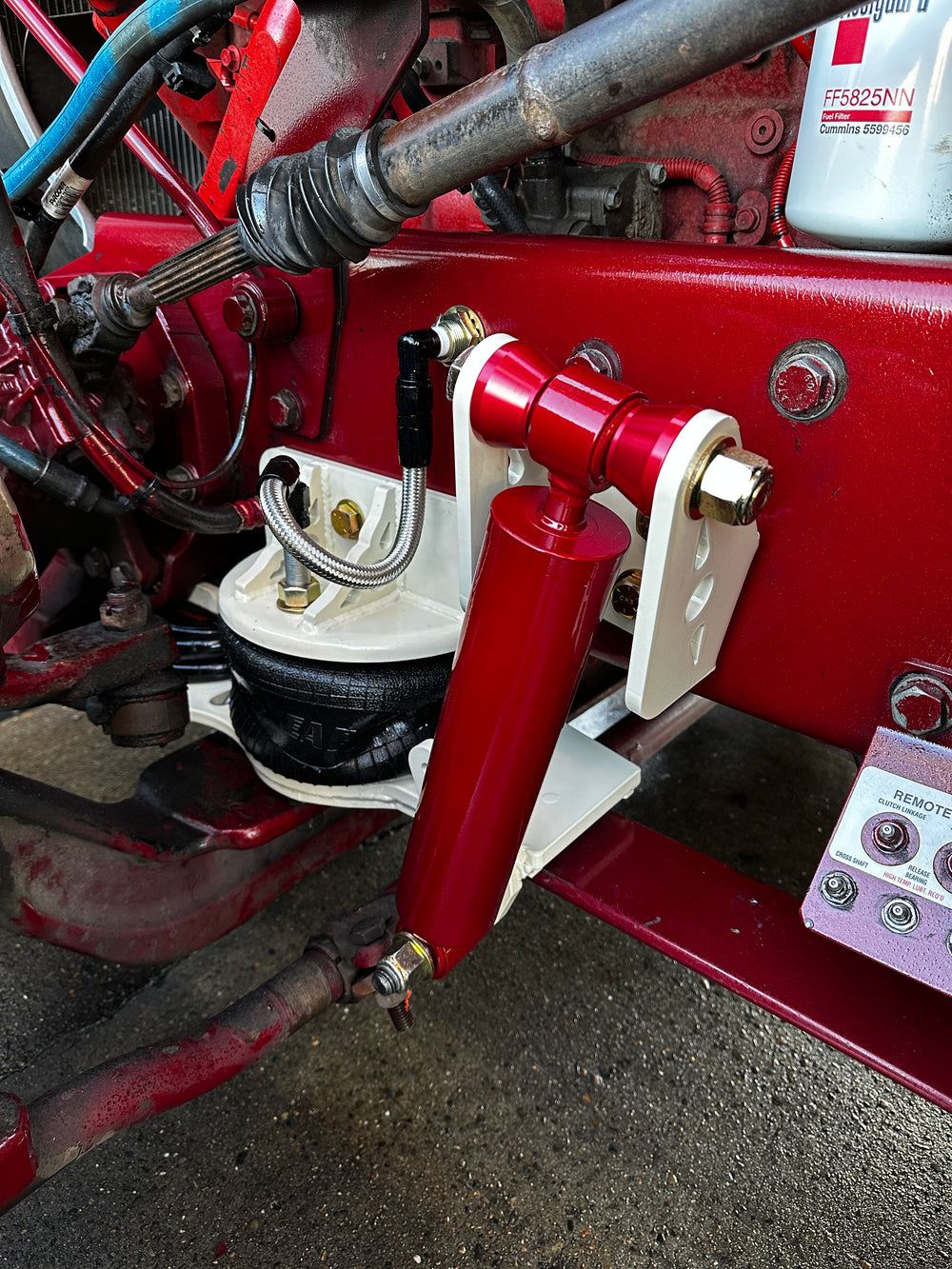 Heavy duty truck steering stabilizer and suspension components close-up on red chassis