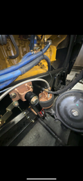 Heavy duty truck engine compartment with hoses, brake booster, and steering linkage visible
