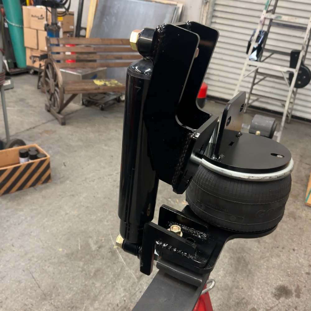 Rowing machine in a workshop setting with tools and equipment in the background