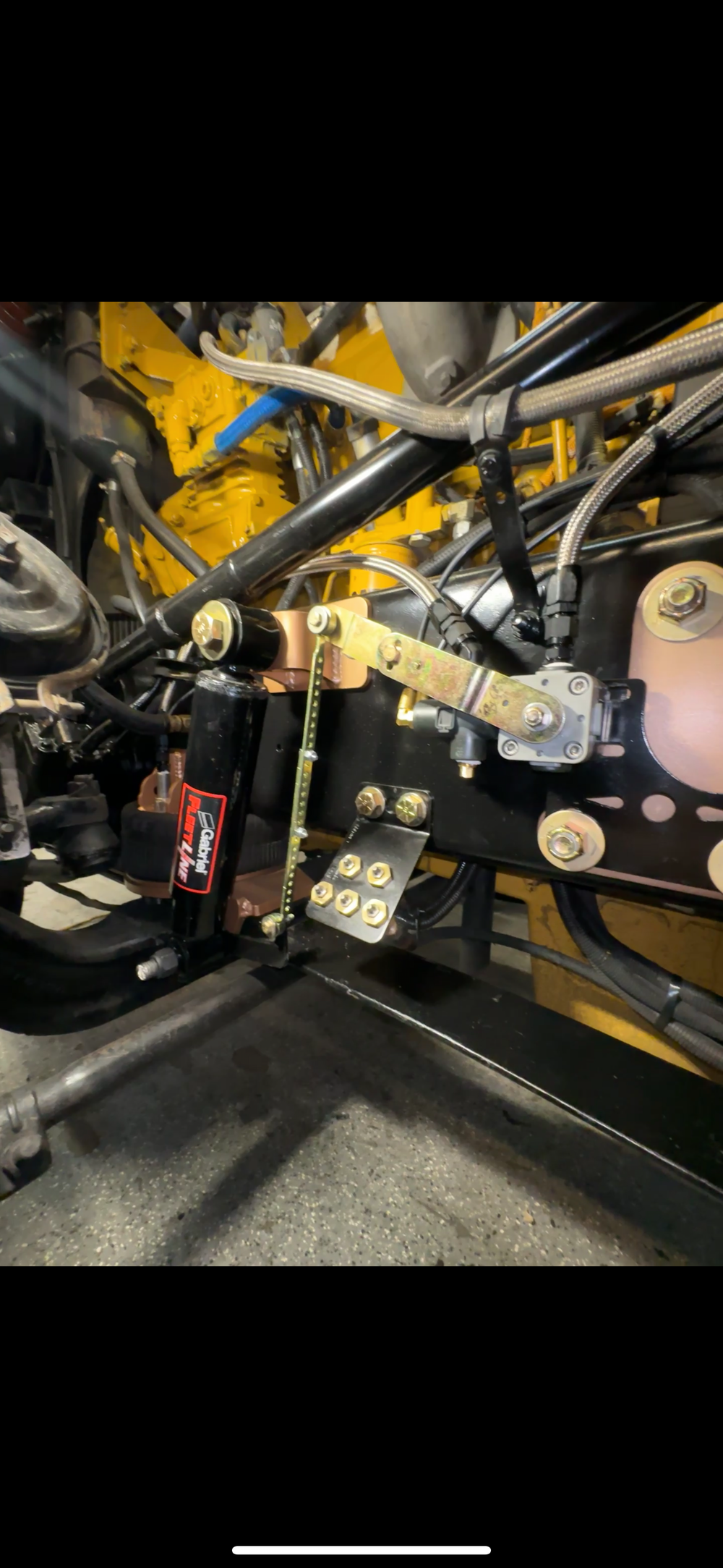 Heavy duty truck steering stabilizer and suspension linkage with steel braided lines