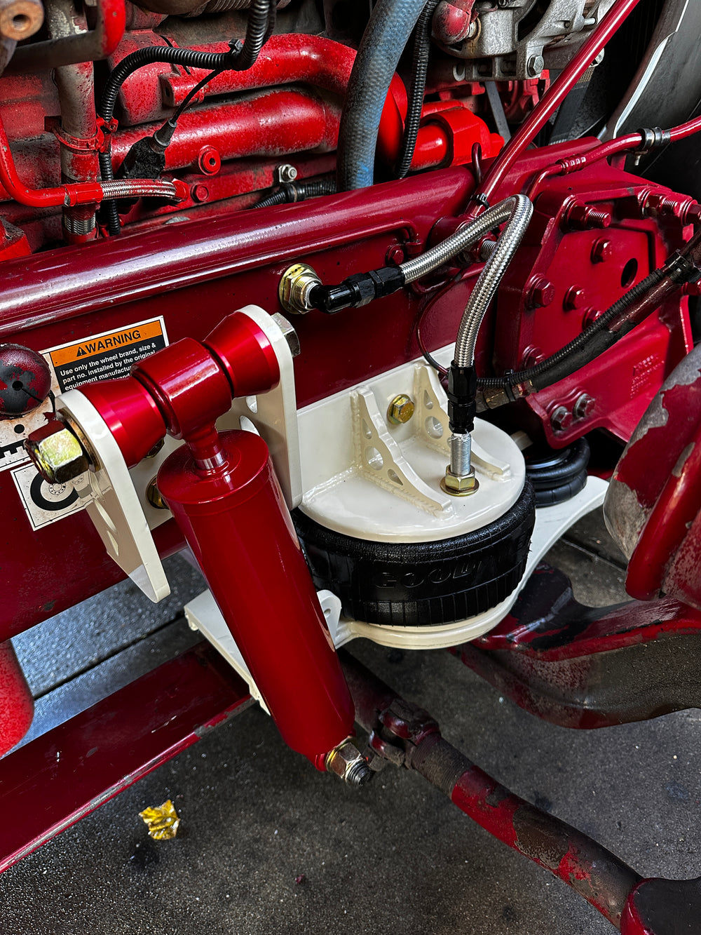 Heavy duty truck suspension system with red and white custom components and air ride parts