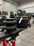 Heavy duty truck air suspension parts with mounting brackets in repair shop setting