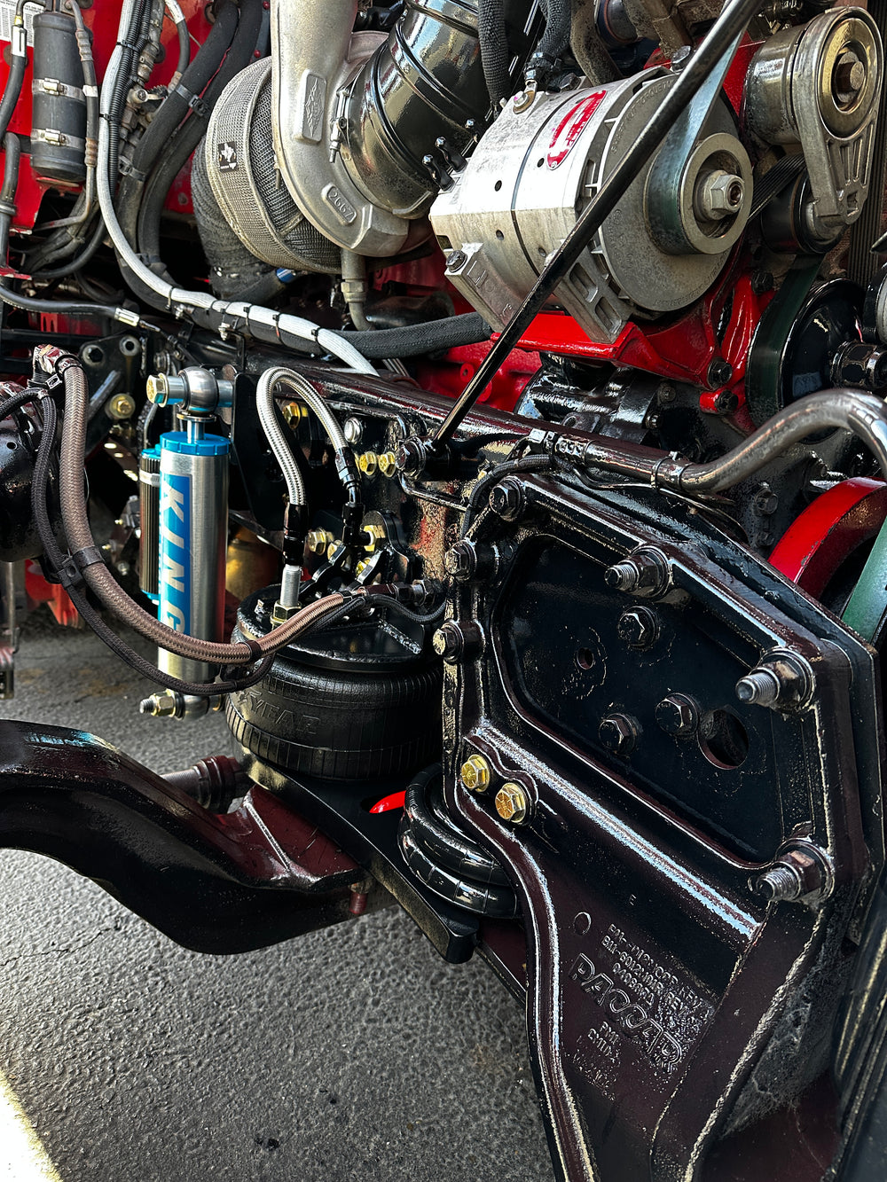 Heavy duty truck engine close-up showing turbo, suspension, and drivetrain components