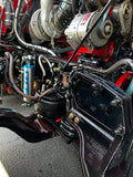 Heavy duty truck engine close-up showing turbo, suspension, and drivetrain components