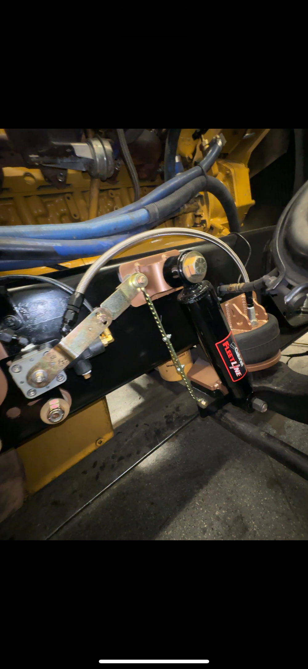 Heavy duty truck suspension and steering components with hoses, brackets, and shock absorber