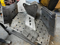 Heavy duty custom metal brackets on a perforated workbench for truck repair fabrication