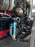 Heavy duty truck engine bay with off-road racing shocks and visible suspension components