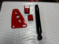 Heavy duty truck suspension parts set with red brackets and black shock absorber on patterned surface