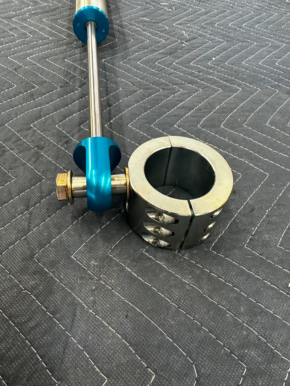 Heavy duty truck drivetrain component with metal shaft and blue anodized parts on quilted surface