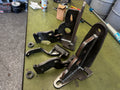 Custom fabricated steel brackets and welds for heavy duty truck repair on workbench