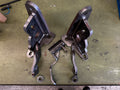 Heavy duty custom metal truck brackets and parts on a workbench, welding visible.