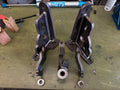 Heavy duty custom fabricated metal brackets and linkage components on workbench