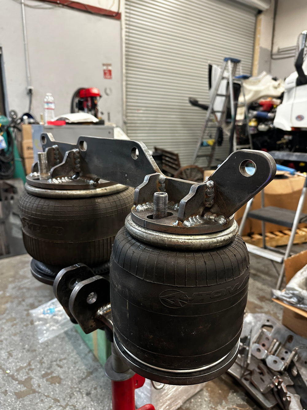 Close-up of a truck suspension system in a workshop setting