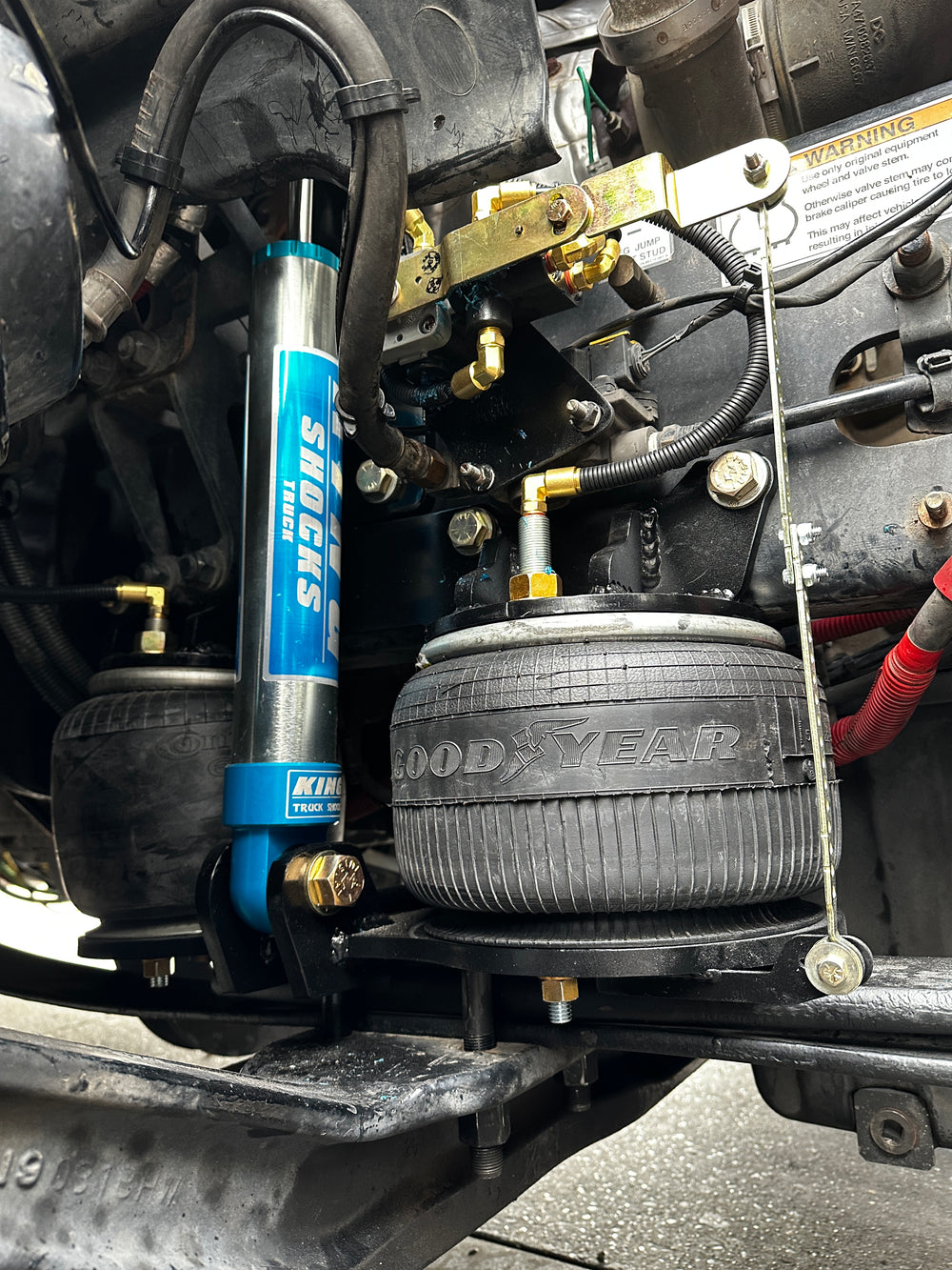 Close-up of a vehicle suspension system with shocks and tires.