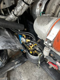 Close-up of a truck air ride system with components like calipers and hoses.